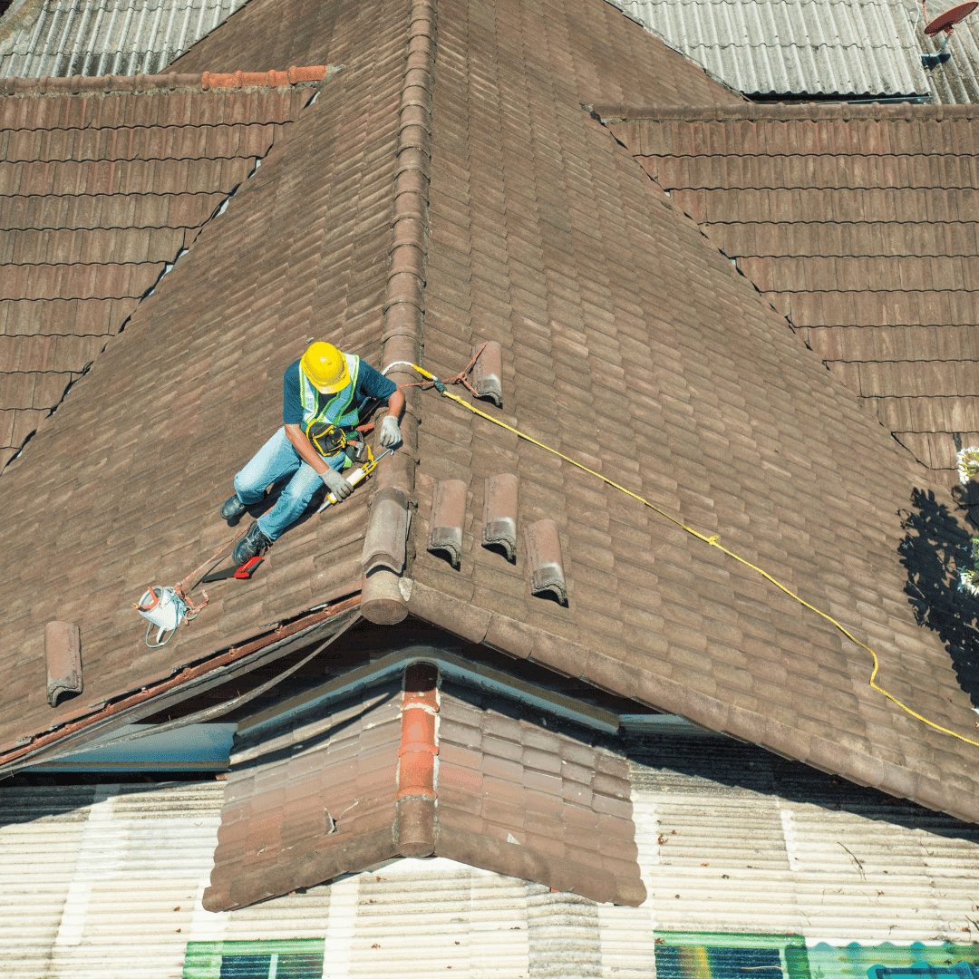 Aerial view of roofer performing preventative maintenance in Crewe