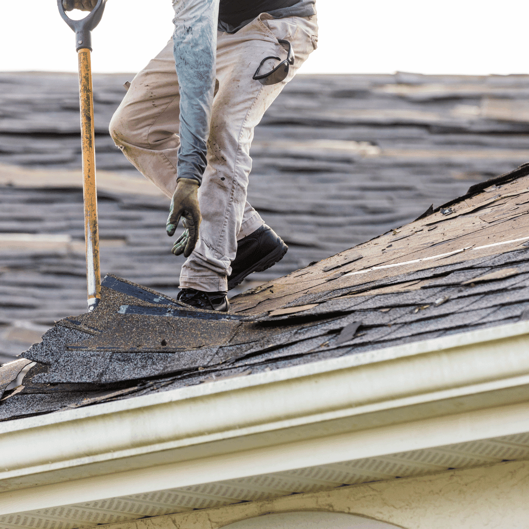 Roofer clearing blocked gutters on a Crewe home